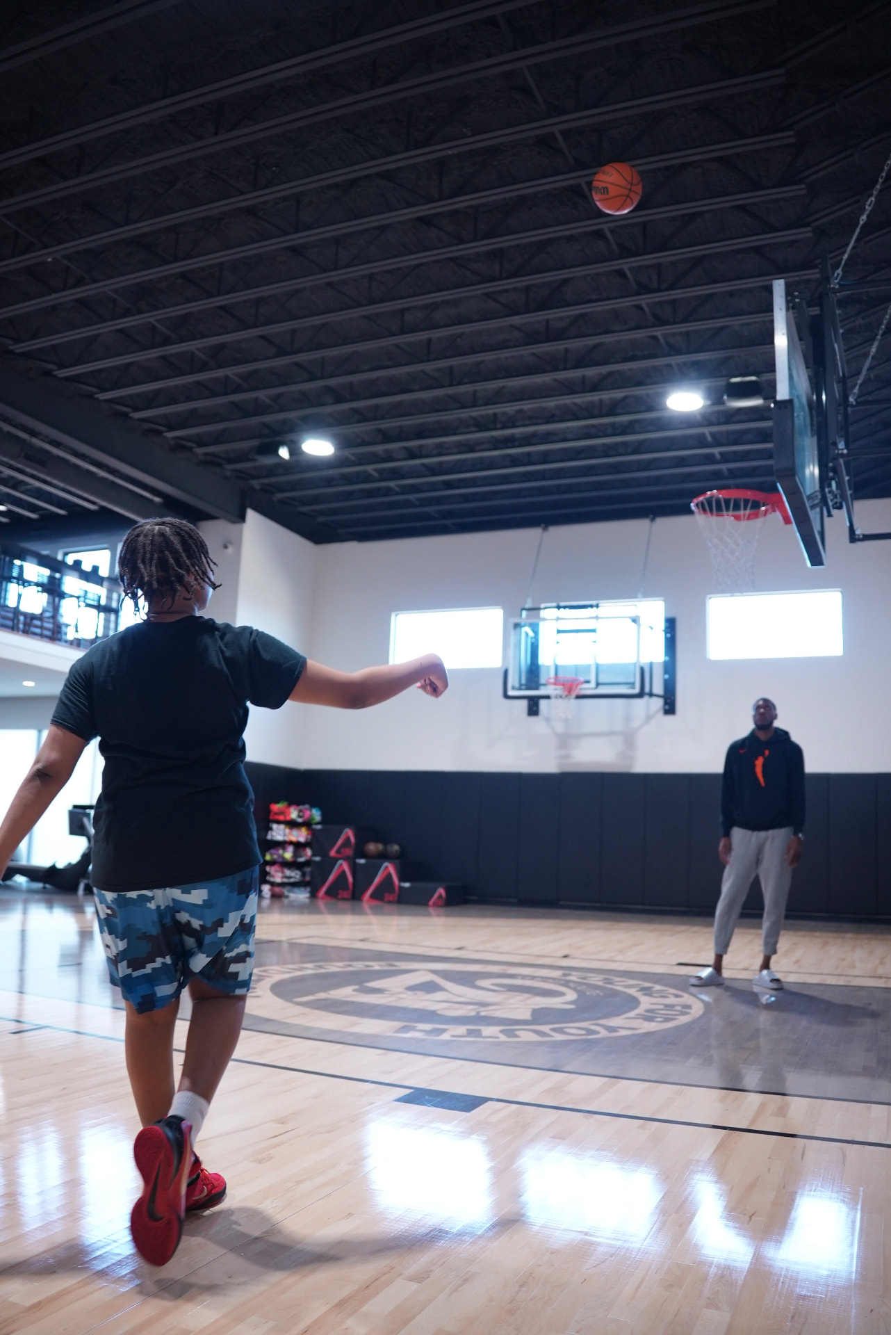 Player shooting on the main court during a training session